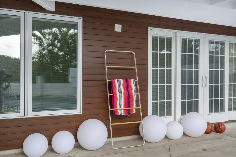 Towel rack in front of metal plank house