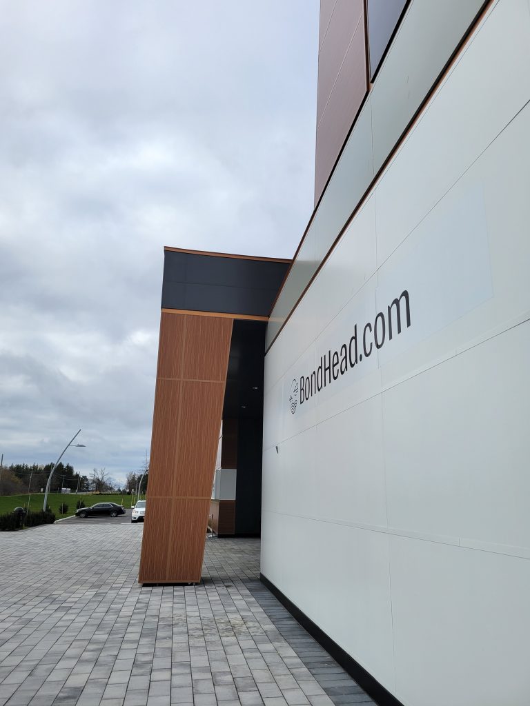 Side view of entrance of building with woodgrain panel