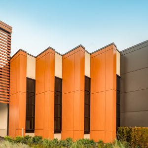 Store with 4 columns of vertical orange metal panels